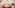 Modern dining area: white table, red chairs, orange pendant, retro mini-fridge.