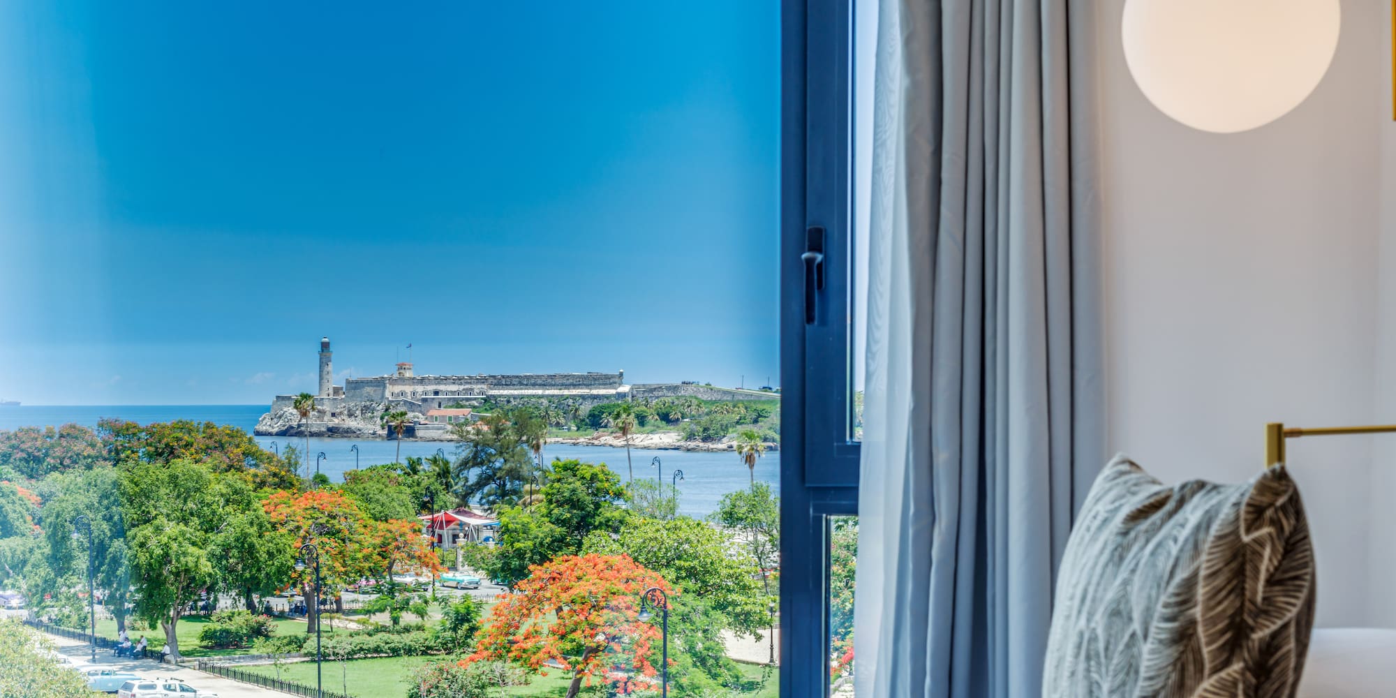 a window with a view of a city and water