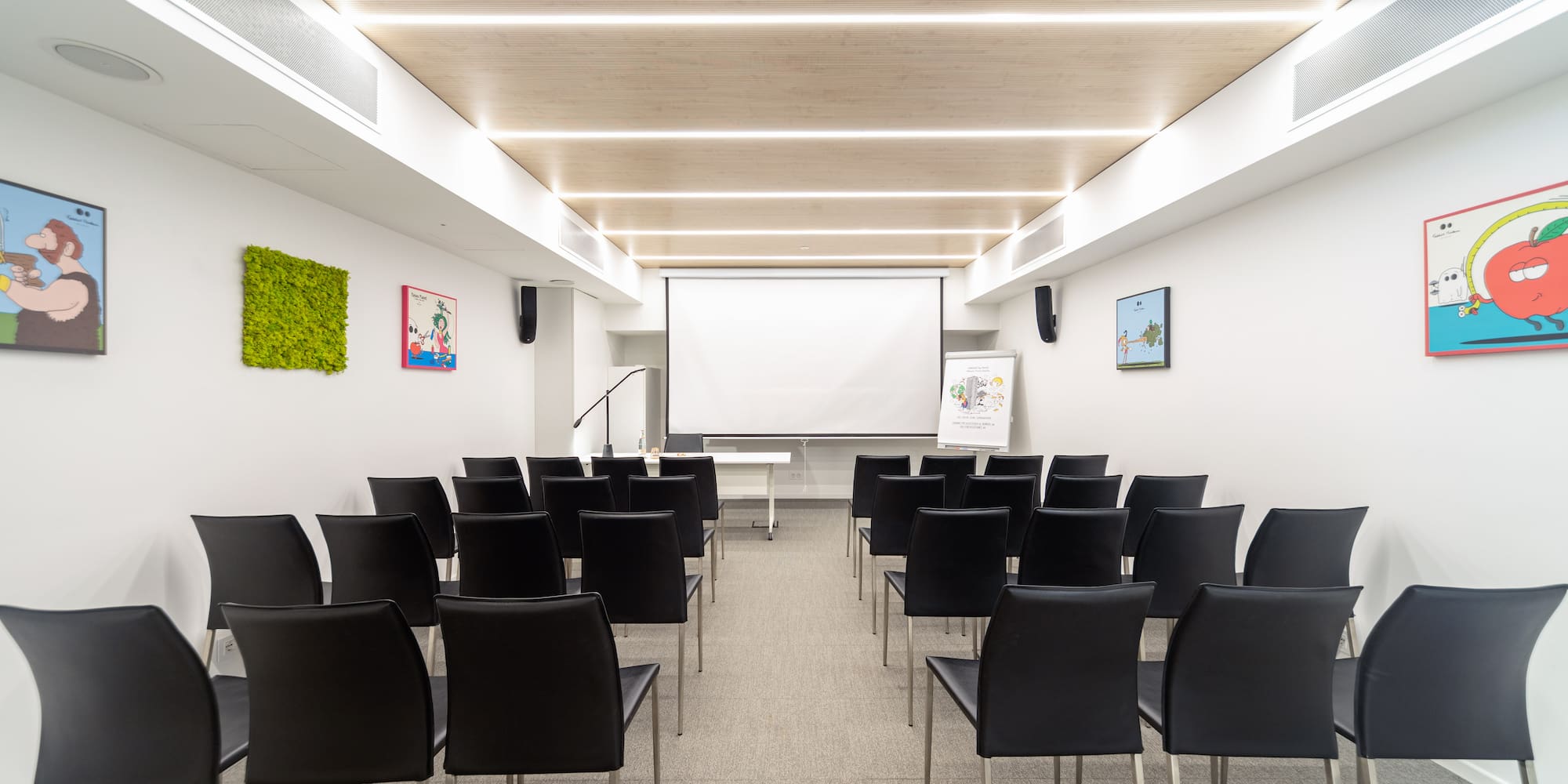 a room with chairs and a projector screen