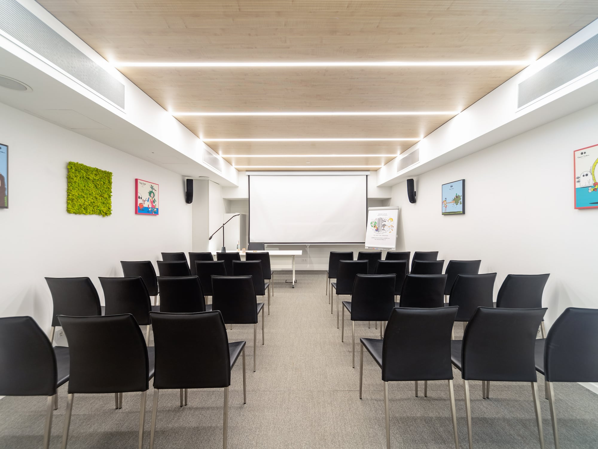 a room with chairs and a projector screen