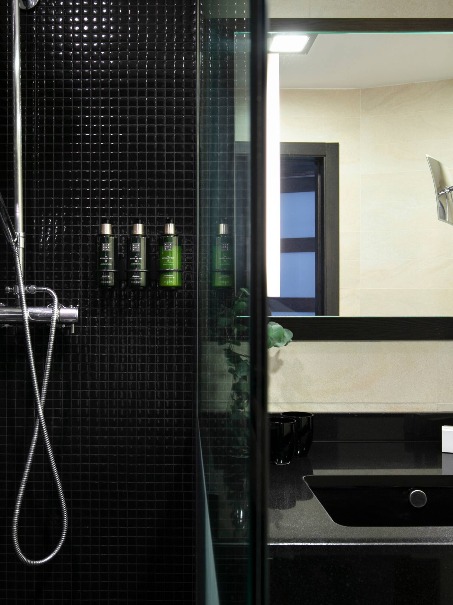 a bathroom with a shower and a sink