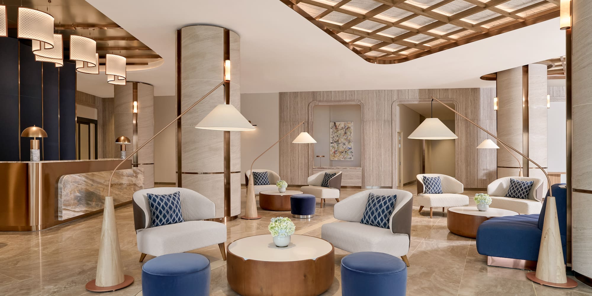 Modern luxury hotel lobby with elegant seating, marble floors, and contemporary lighting.