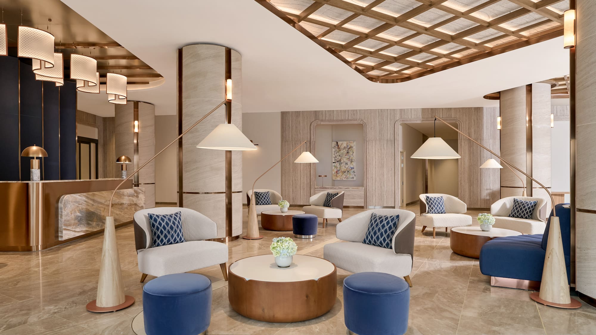 Modern luxury hotel lobby with elegant seating, marble floors, and contemporary lighting.