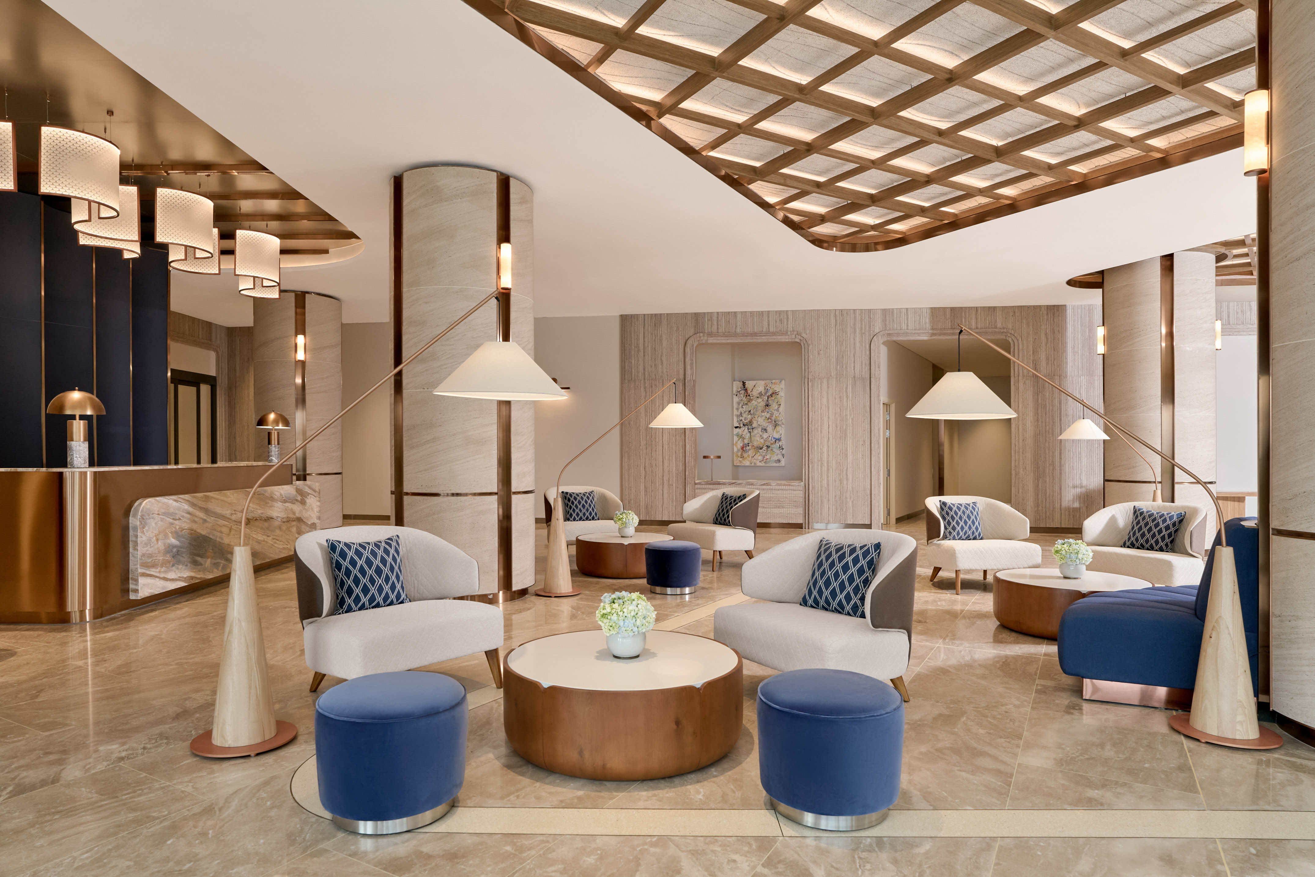 Modern luxury hotel lobby with elegant seating, marble floors, and contemporary lighting.