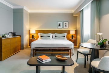 a bedroom with a bed and a table