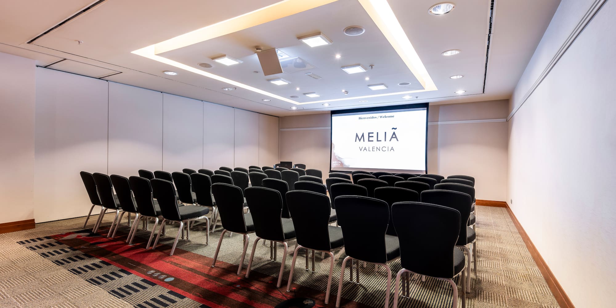a room with chairs and a projector screen