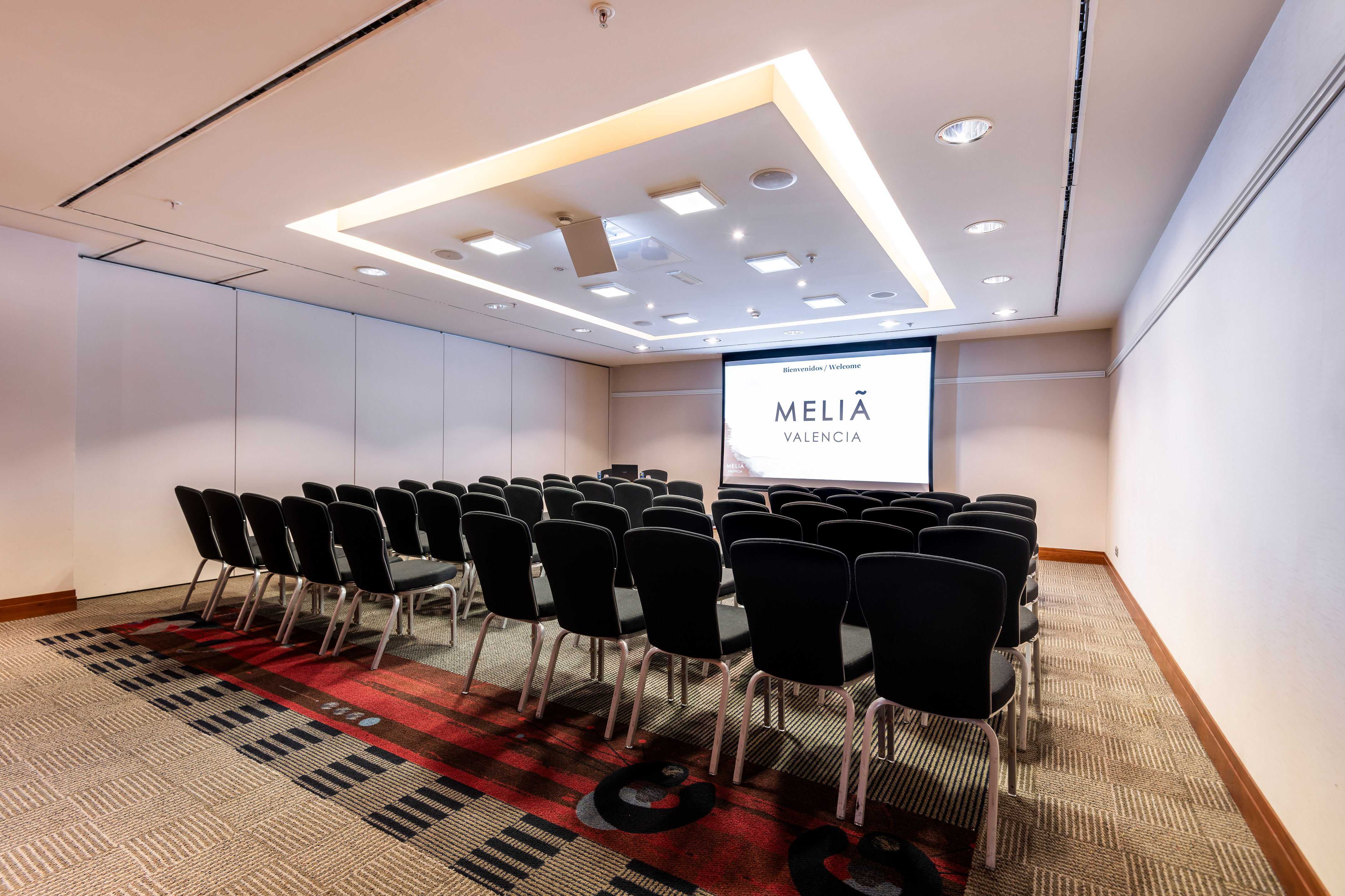 a room with chairs and a projector screen