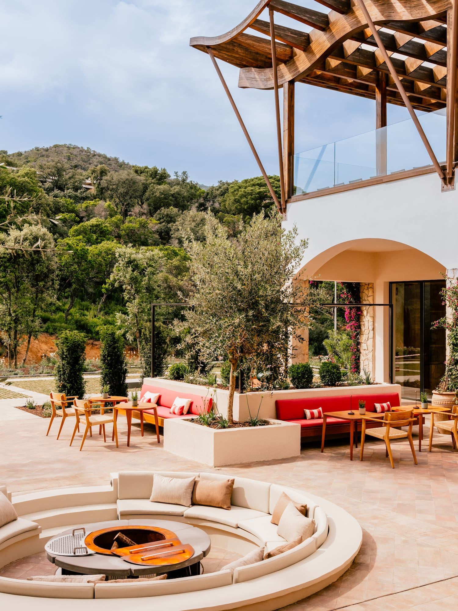 a patio with a round table and chairs