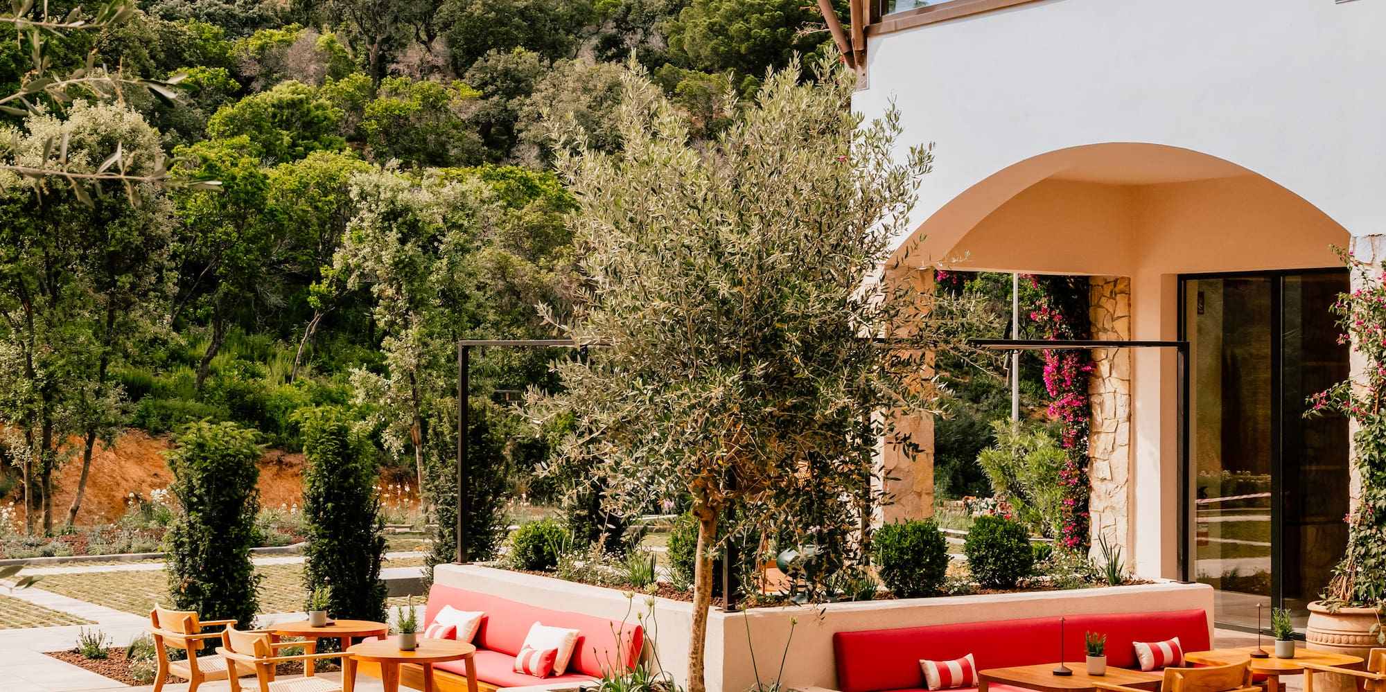 a patio with a round table and chairs