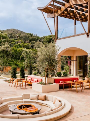 a patio with a round table and chairs