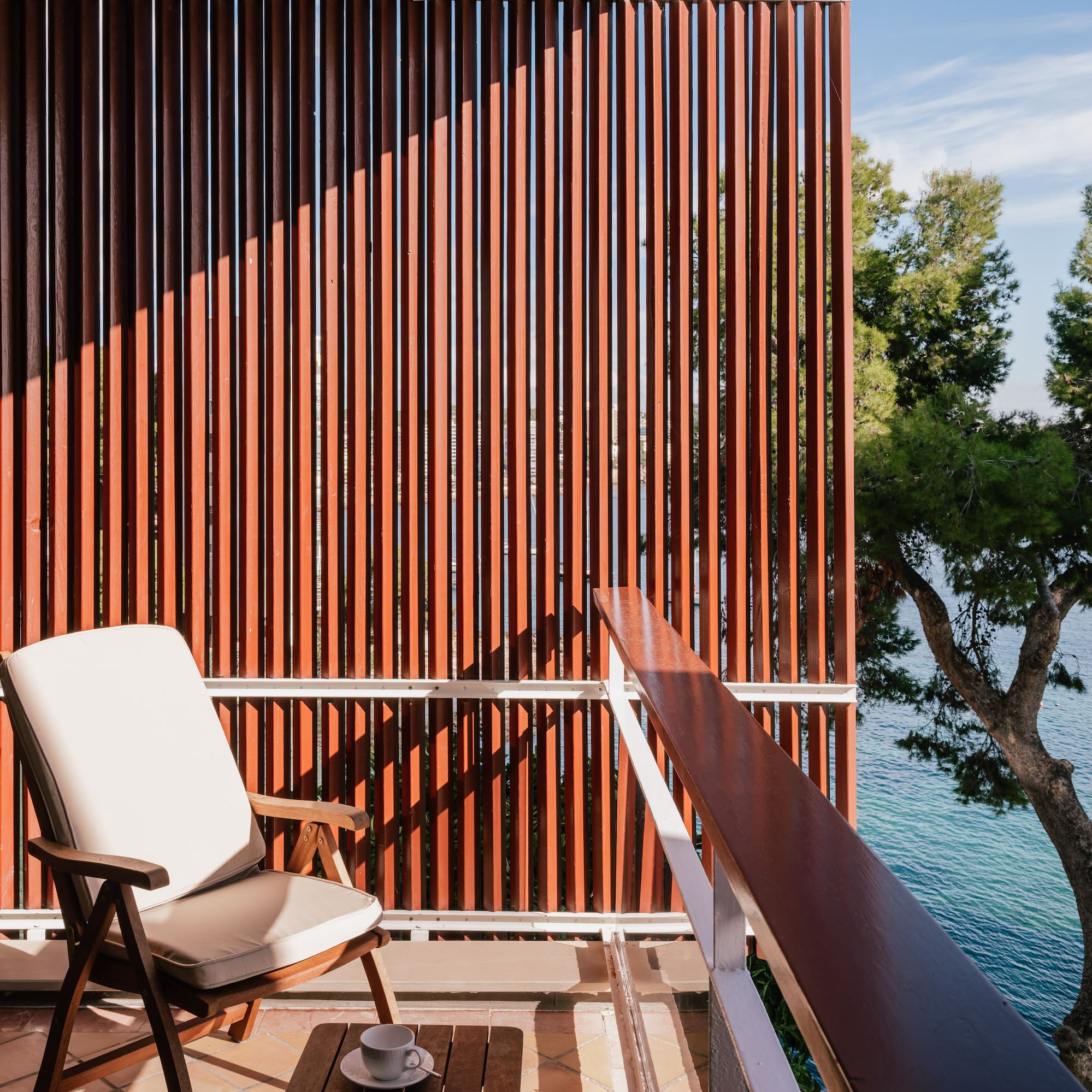 a chair on a balcony overlooking water