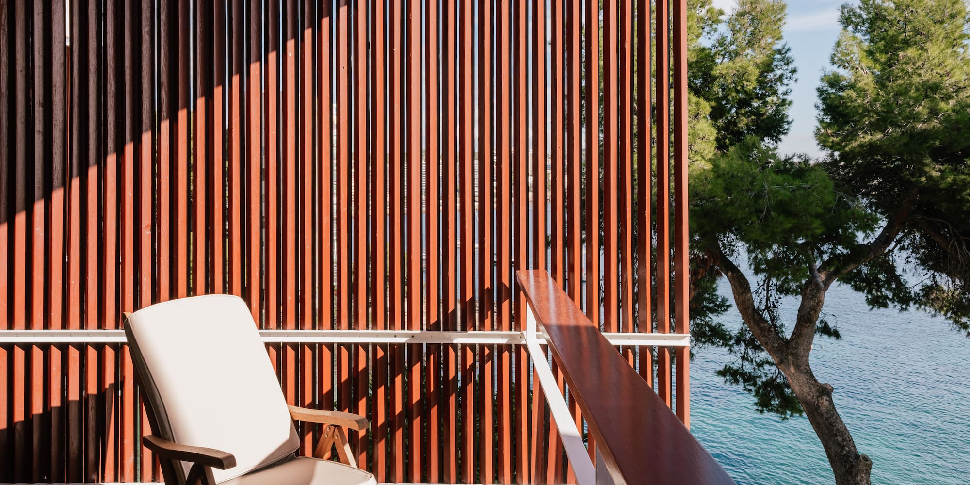 a chair on a balcony overlooking water