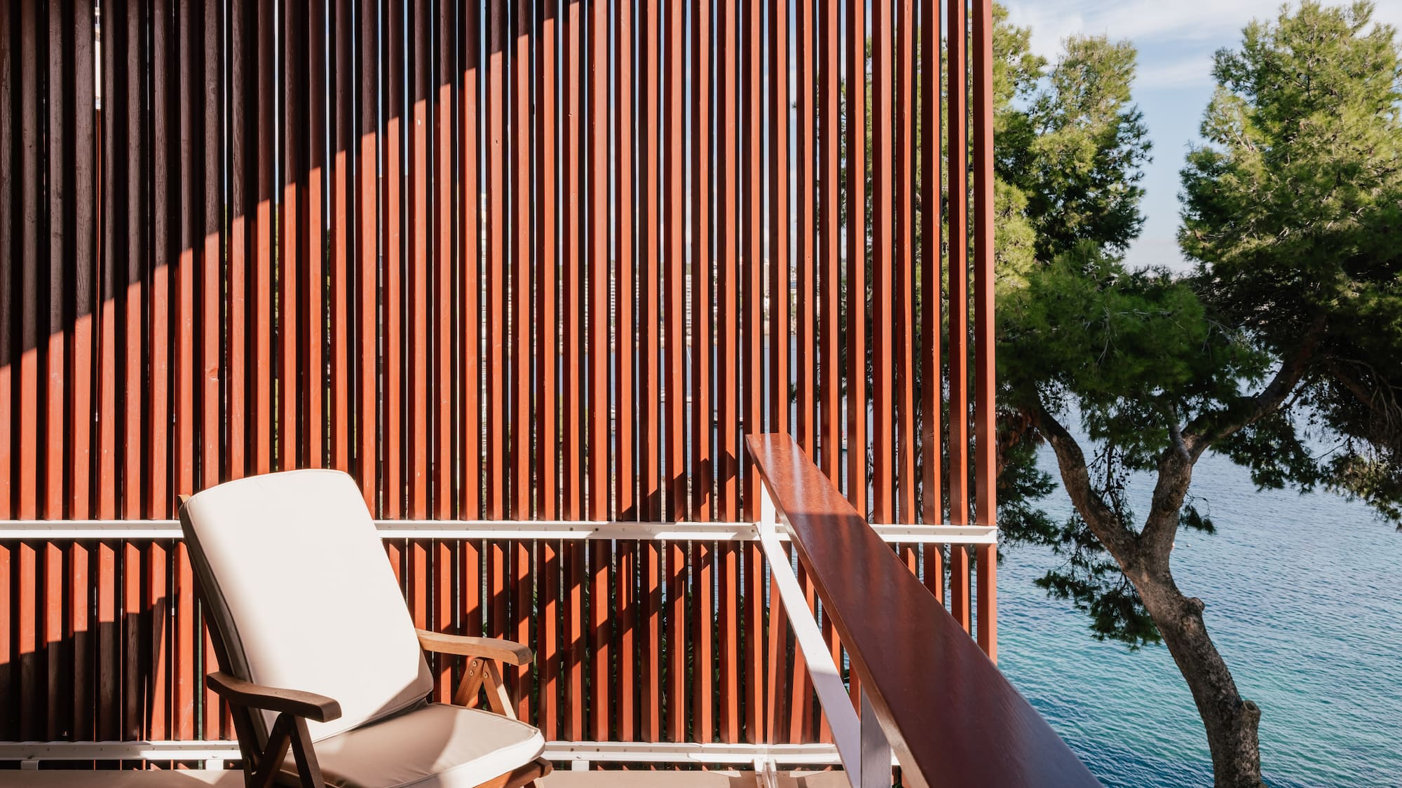 a chair on a balcony overlooking water
