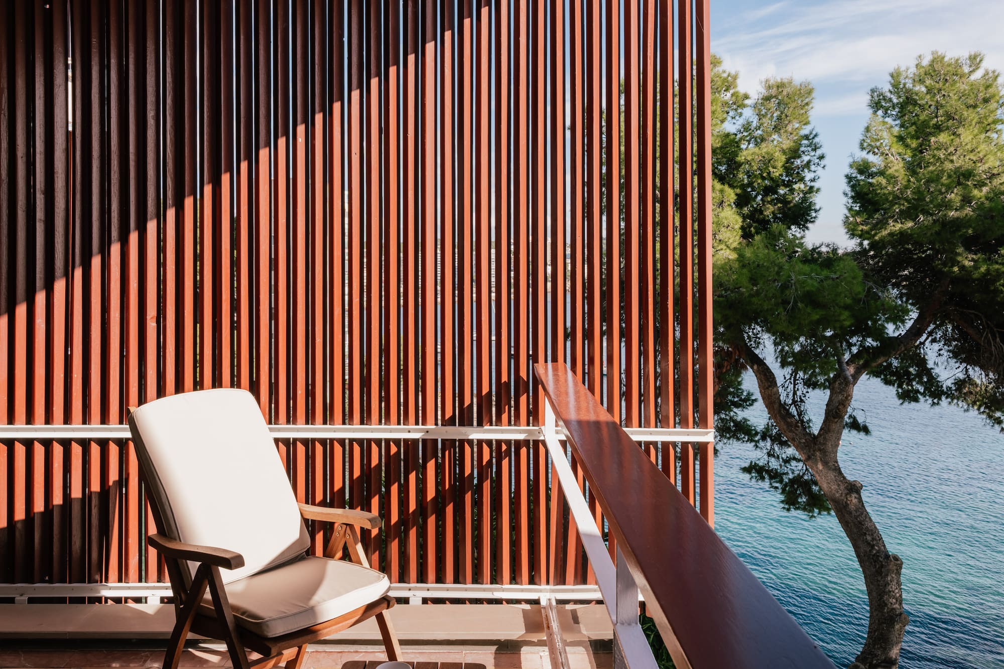 a chair on a balcony overlooking water