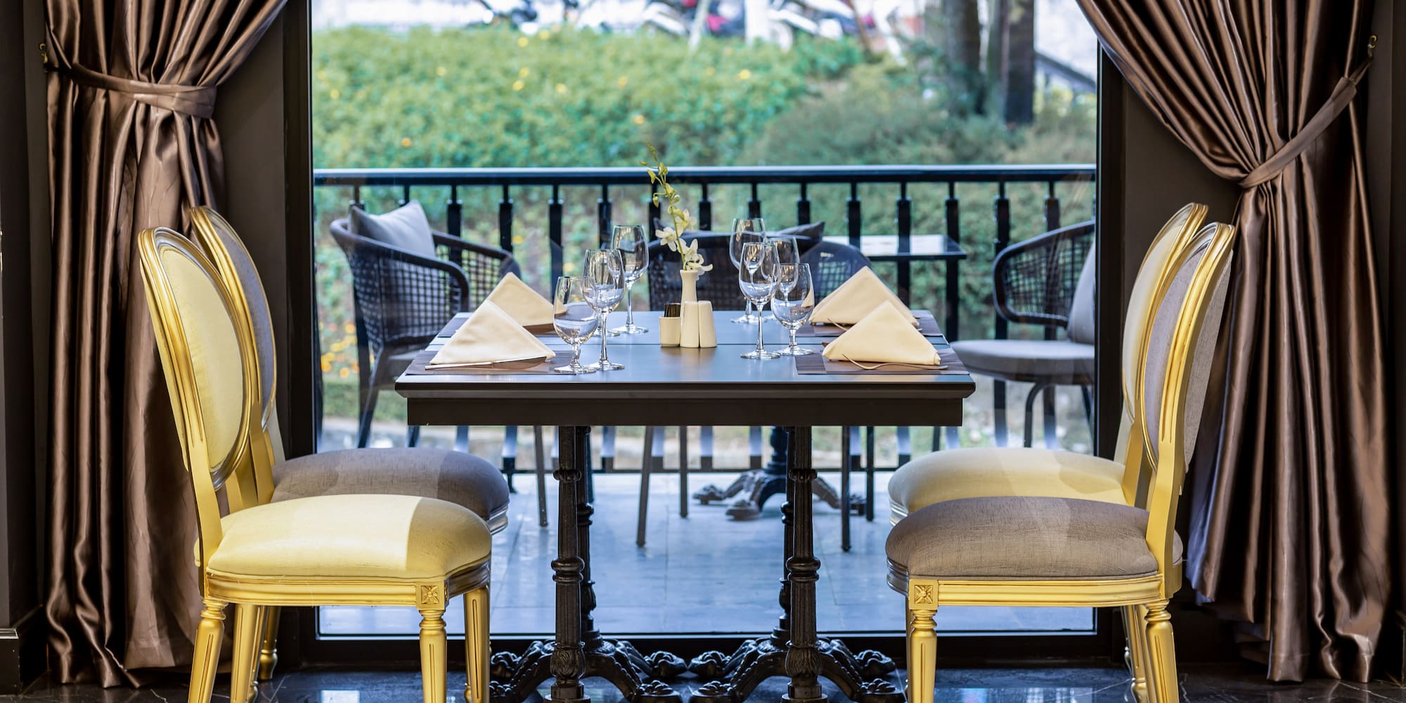 a table with chairs and a curtain