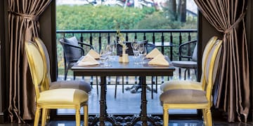 a table with chairs and a curtain