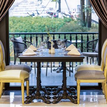 a table with chairs and a curtain