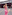 Woman in pink outfit holding flowers on Berlin street, Bahnhof Friedrichstrasse.