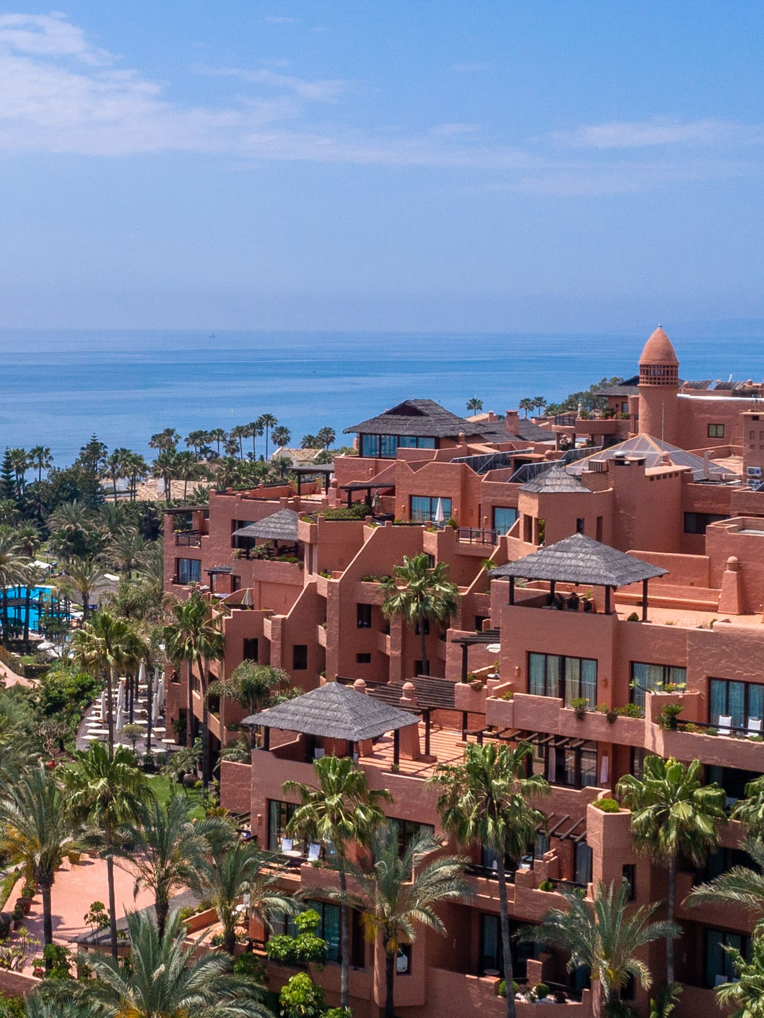 a large building with many windows and a body of water