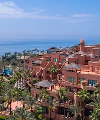 a large building with many windows and a body of water