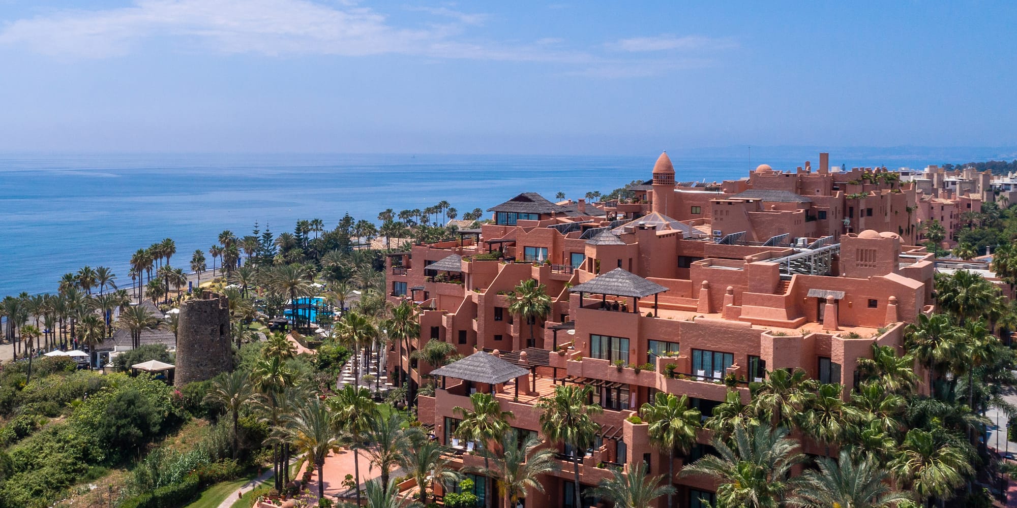 a large building with many windows and a body of water