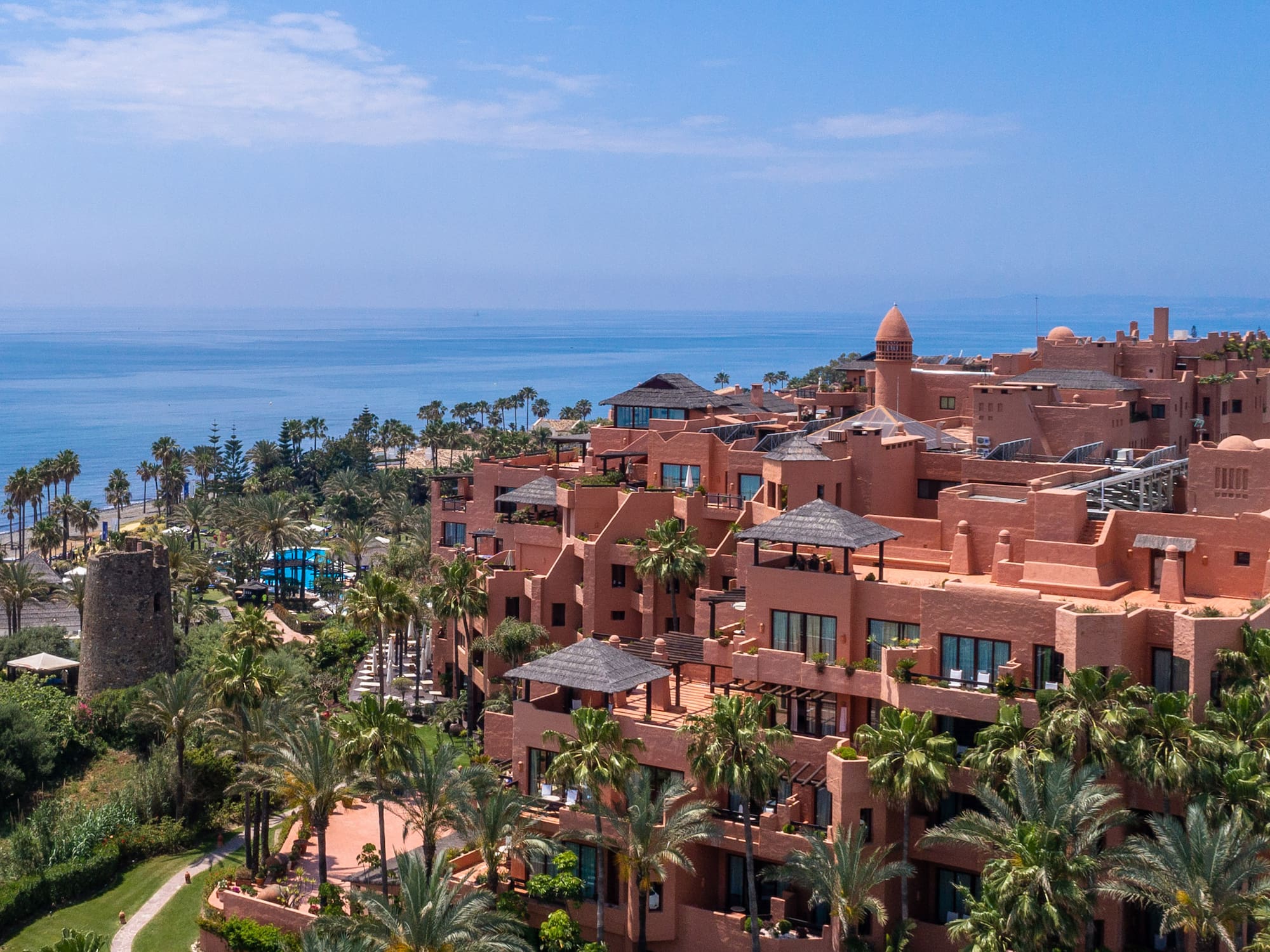 a large building with many windows and a body of water