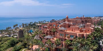 a large building with many windows and a body of water
