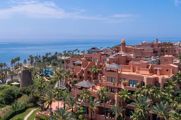 a large building with many windows and a body of water
