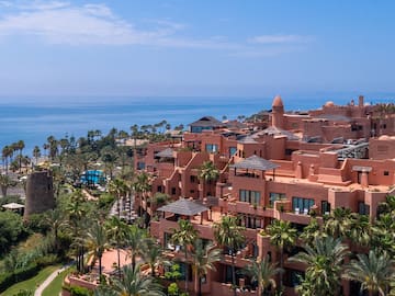 a large building with many windows and a body of water