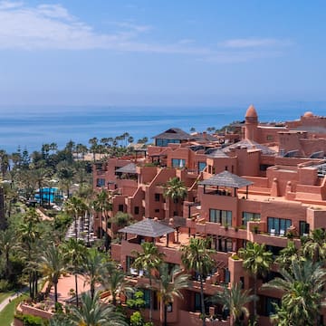 a large building with many windows and a body of water
