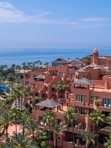 a large building with many windows and a body of water