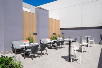 a patio with chairs and tables