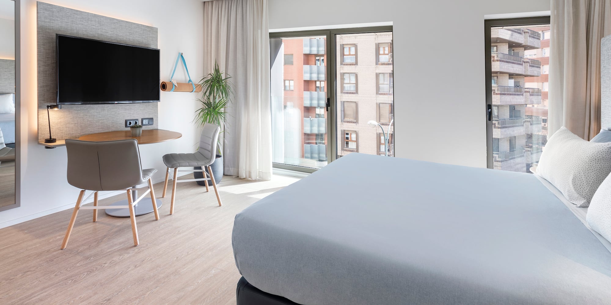 a bedroom with a tv and a table