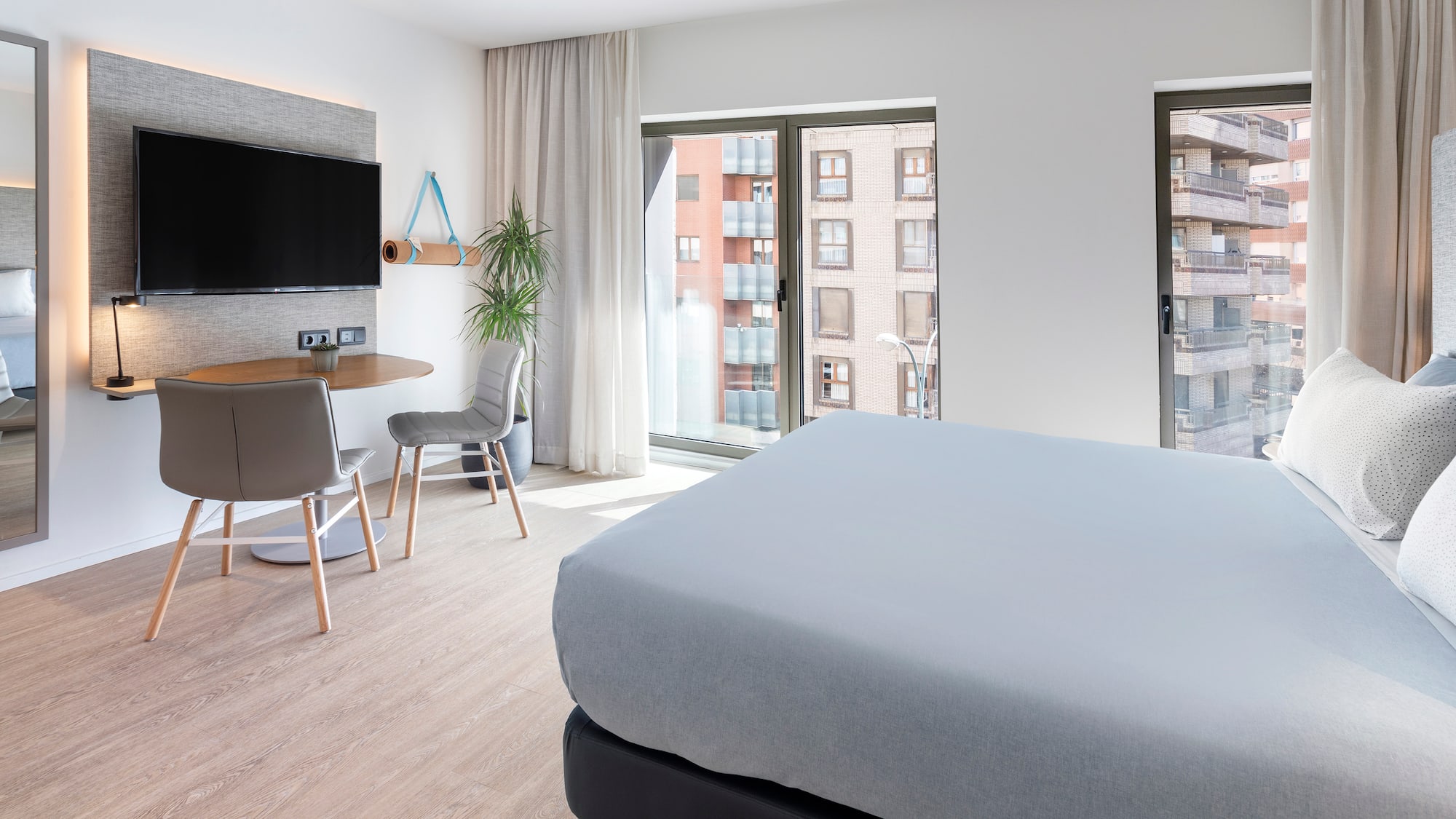 a bedroom with a tv and a table