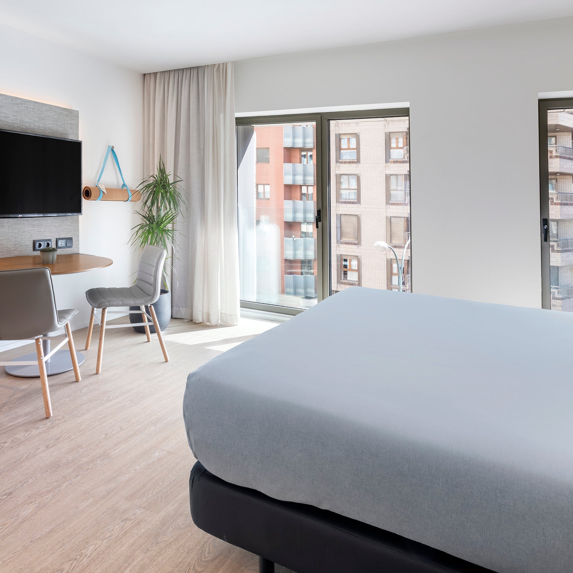 a bedroom with a tv and a table