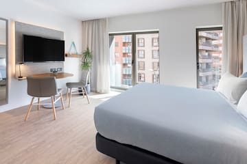 a bedroom with a tv and a table