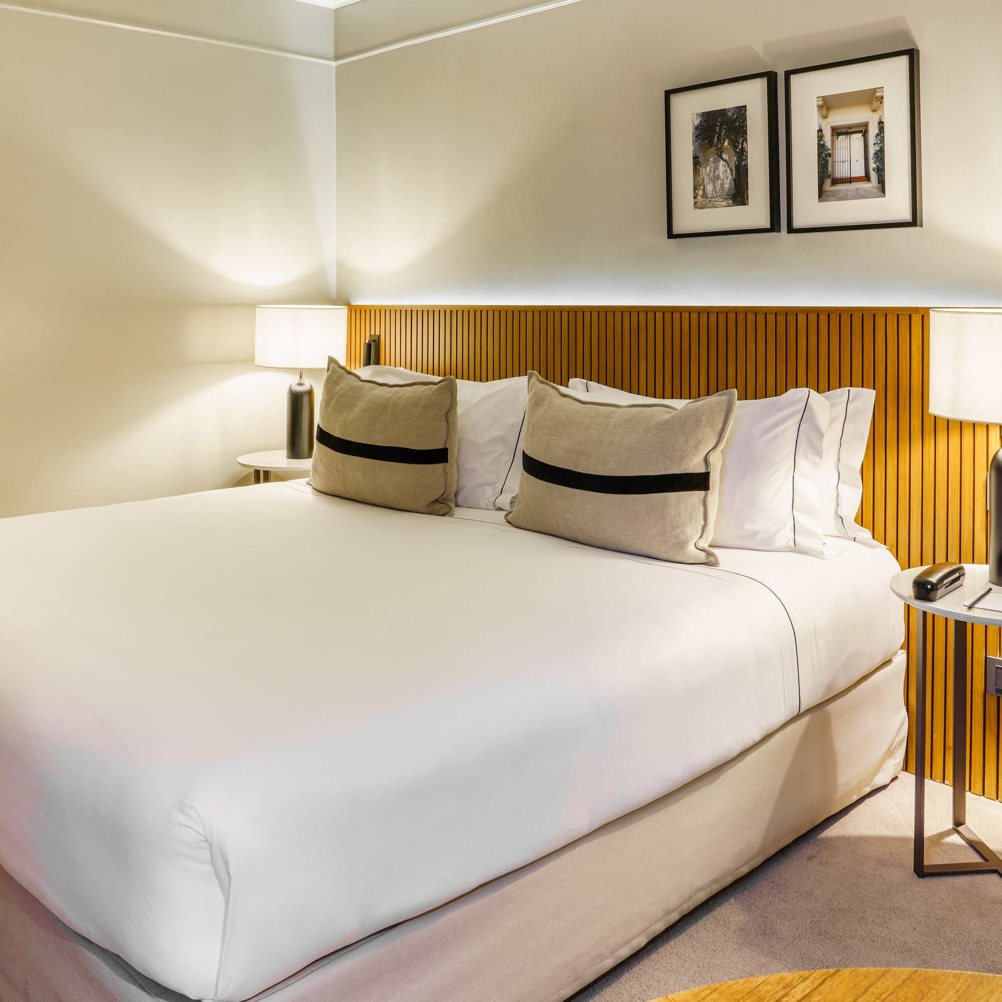 a bed with white sheets and pillows