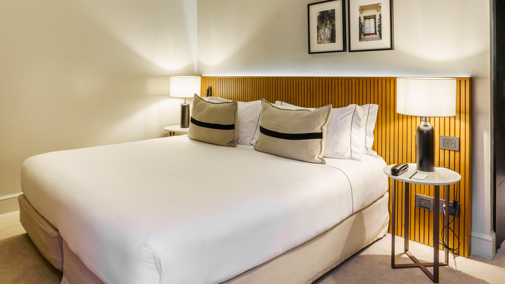 a bed with white sheets and pillows