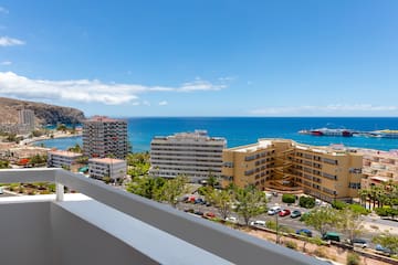 a view of a city and the water from a balcony