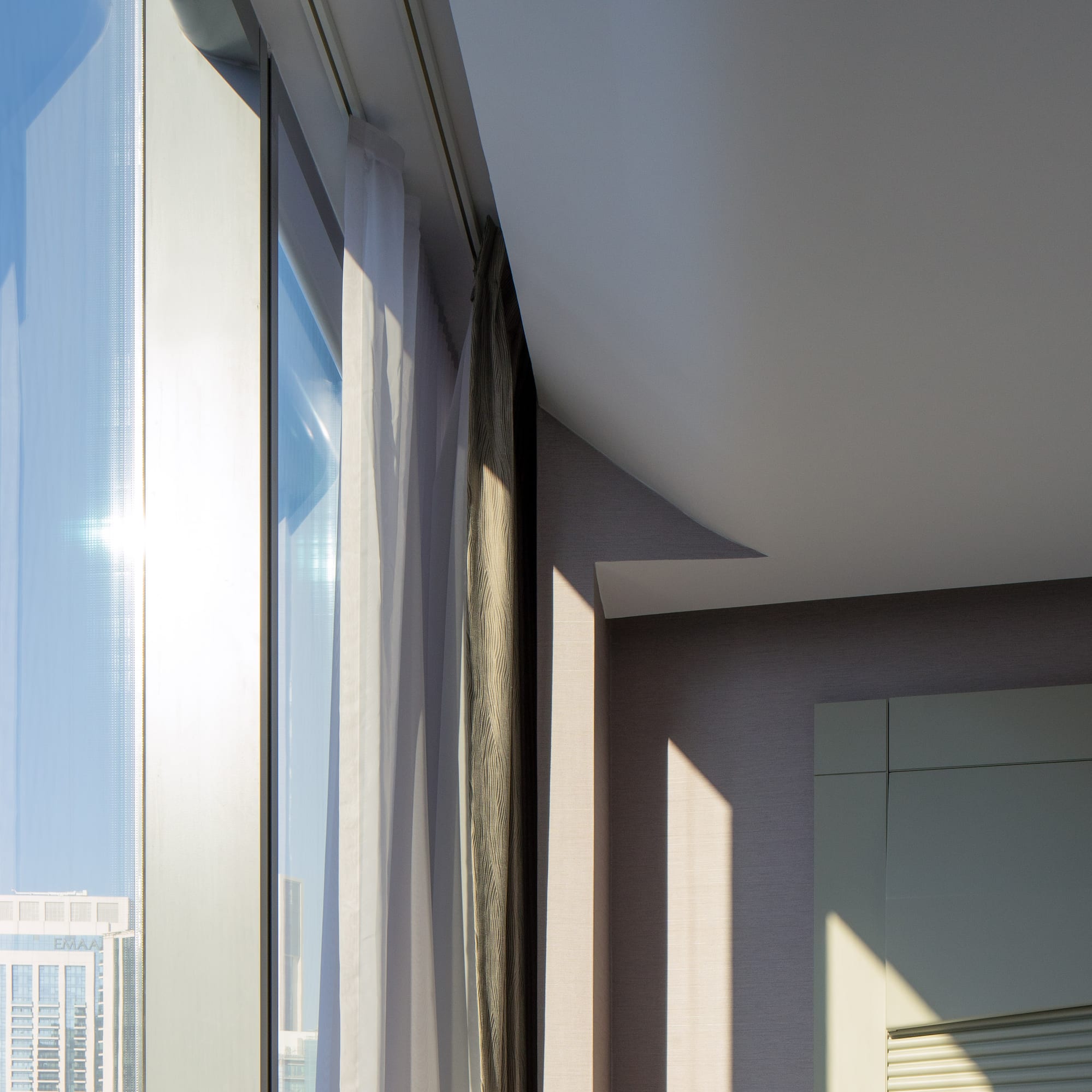 a room with a window and a city skyline