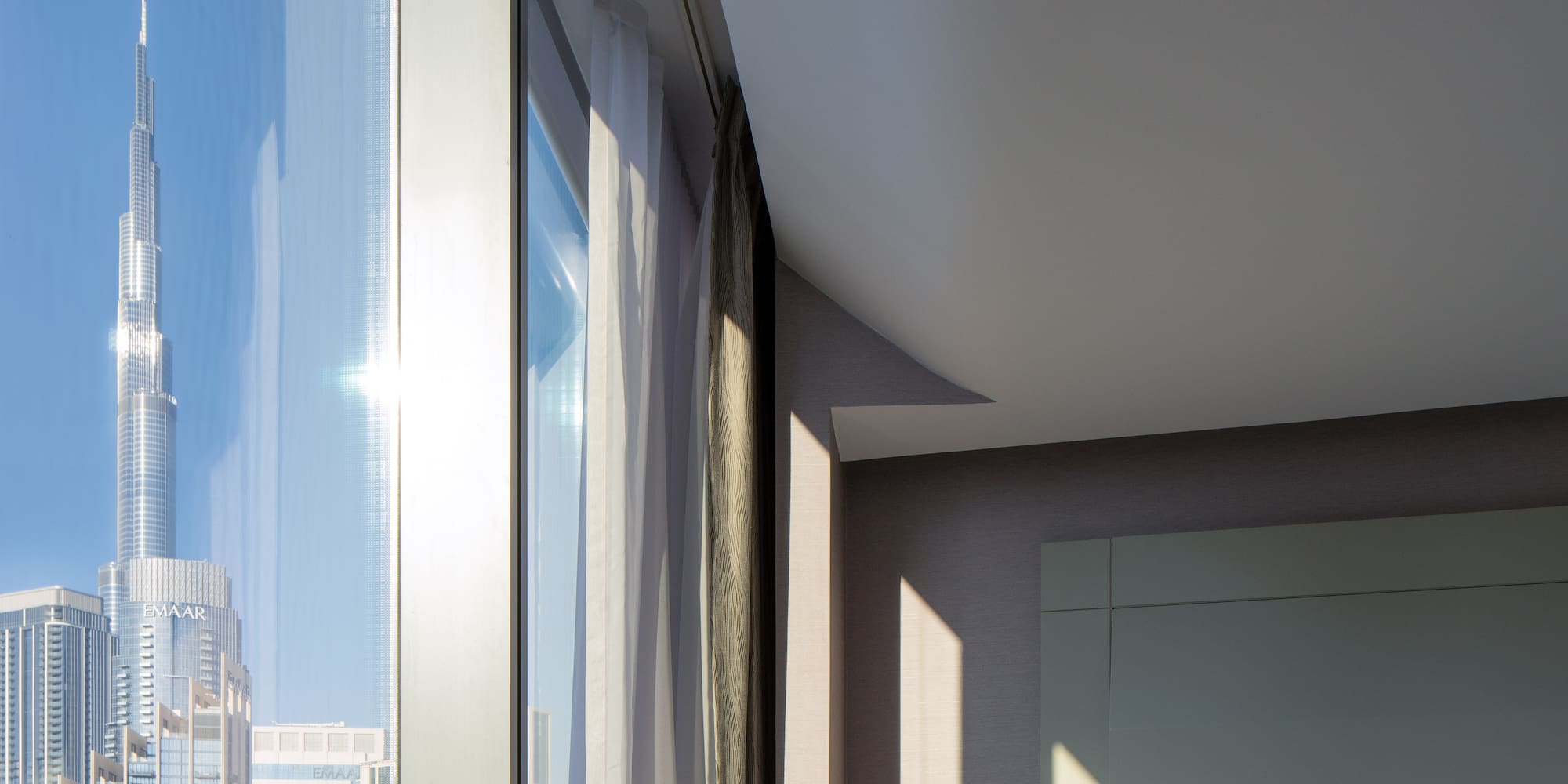 a room with a window and a city skyline