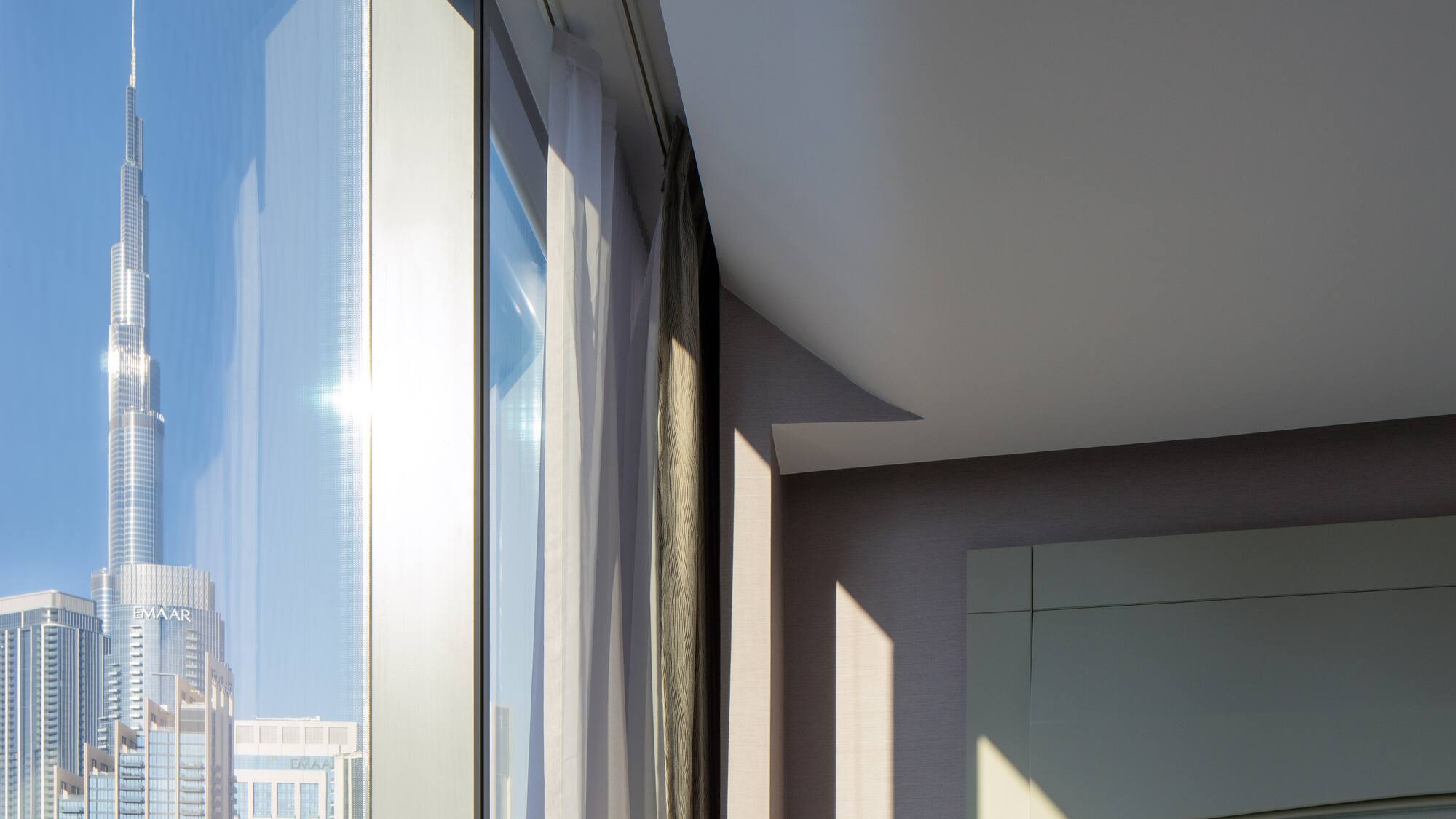 a room with a window and a city skyline