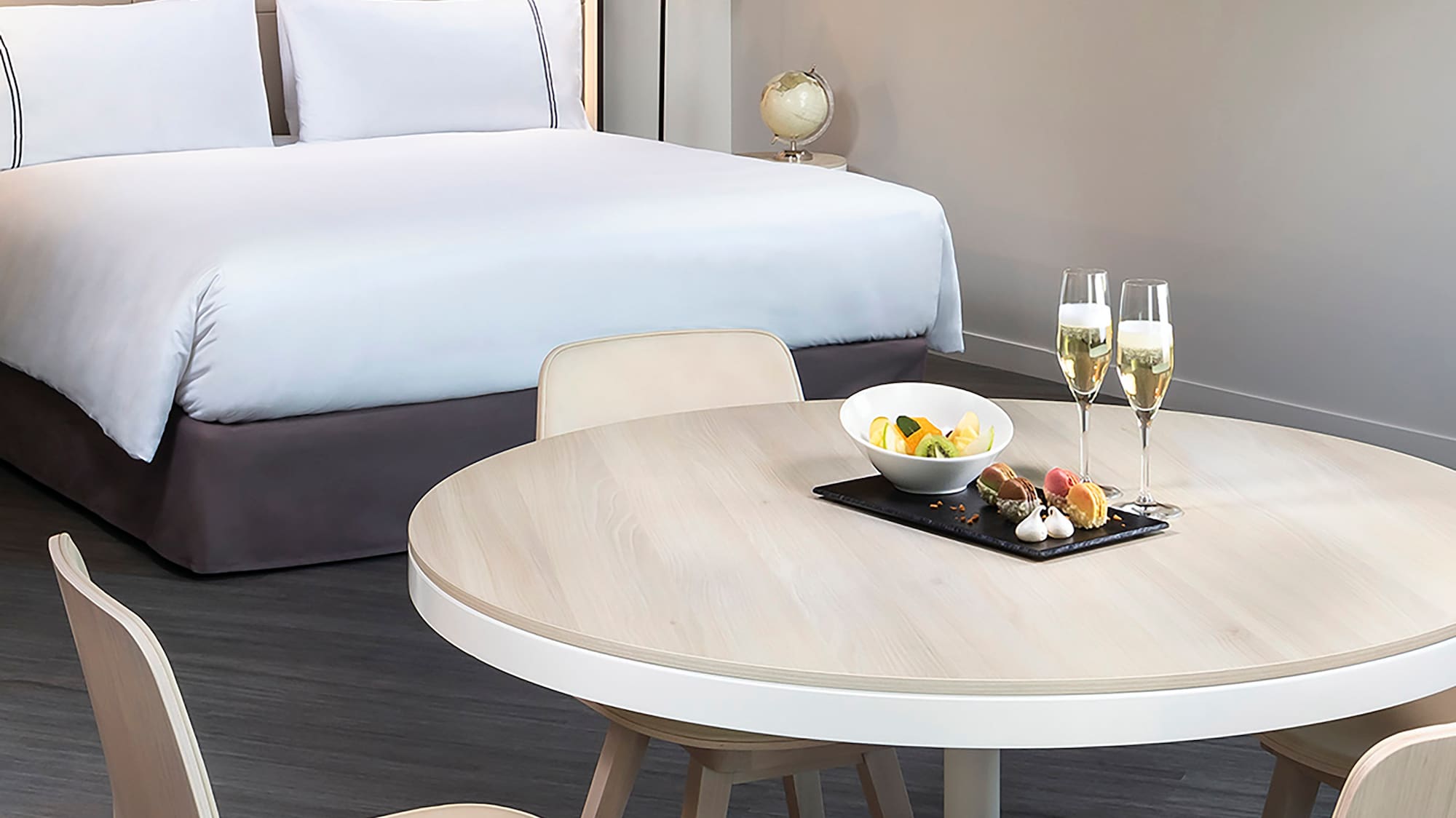 a table with food on it and a bed with a bed and a lamp