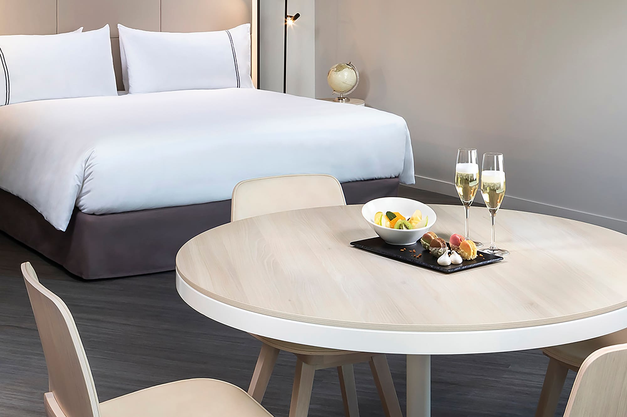 a table with food on it and a bed with a bed and a lamp