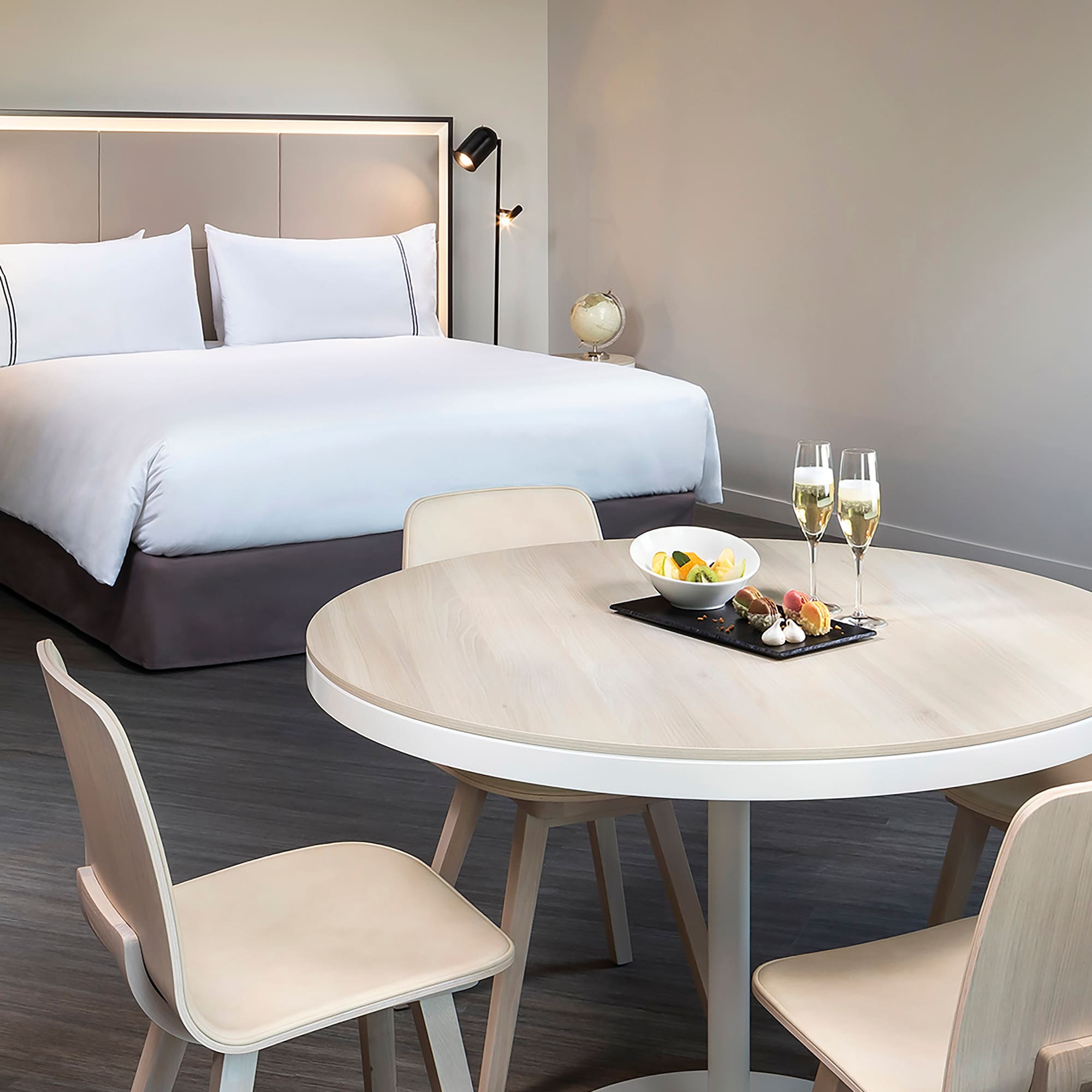 a table with food on it and a bed with a bed and a lamp