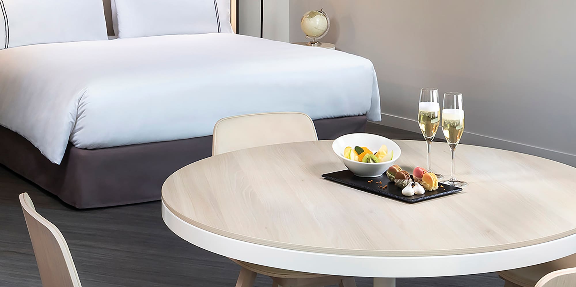 a table with food on it and a bed with a bed and a lamp