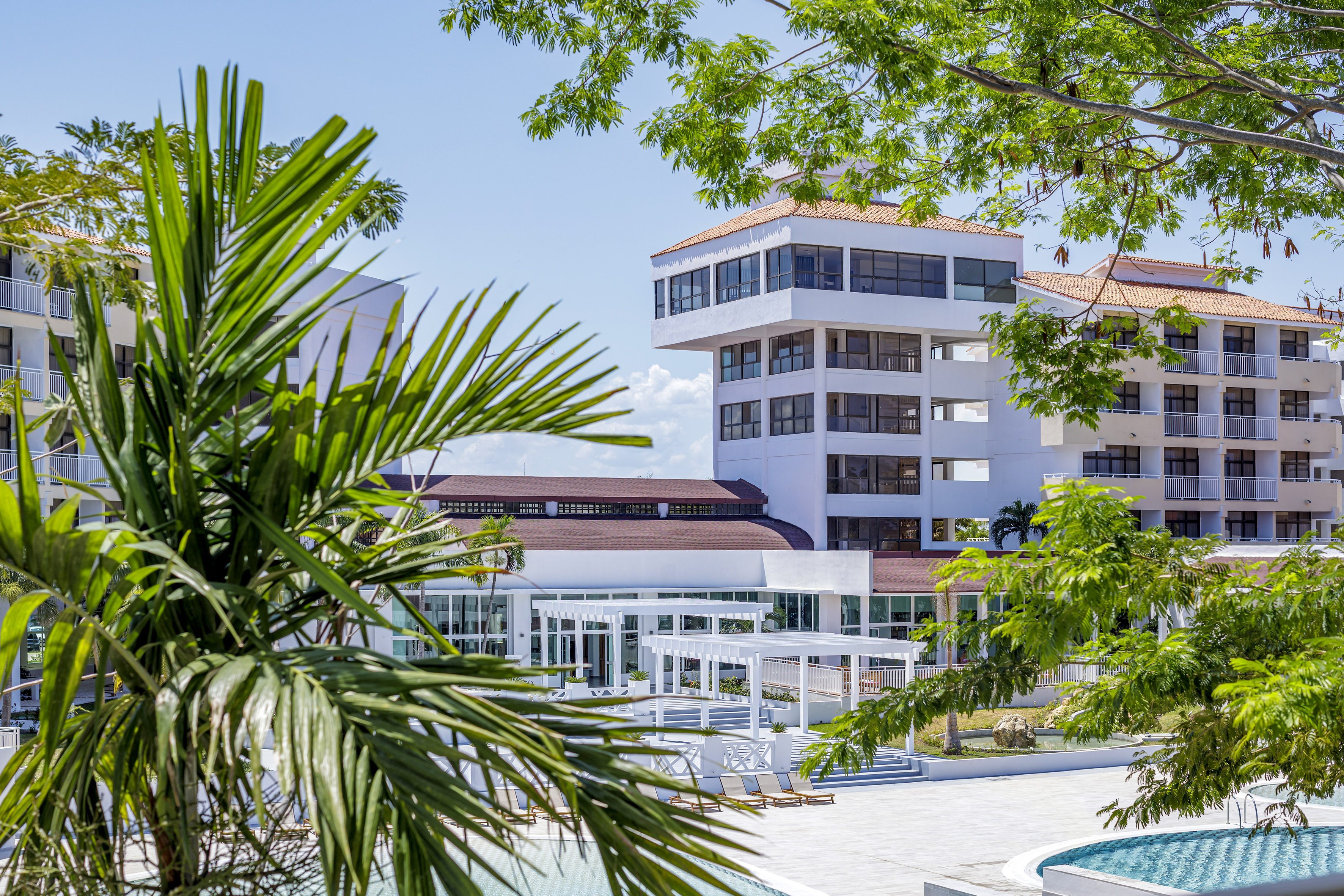 a building with a pool and trees