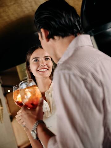 a man and woman holding wine glasses