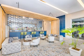 a room with a bar and chairs