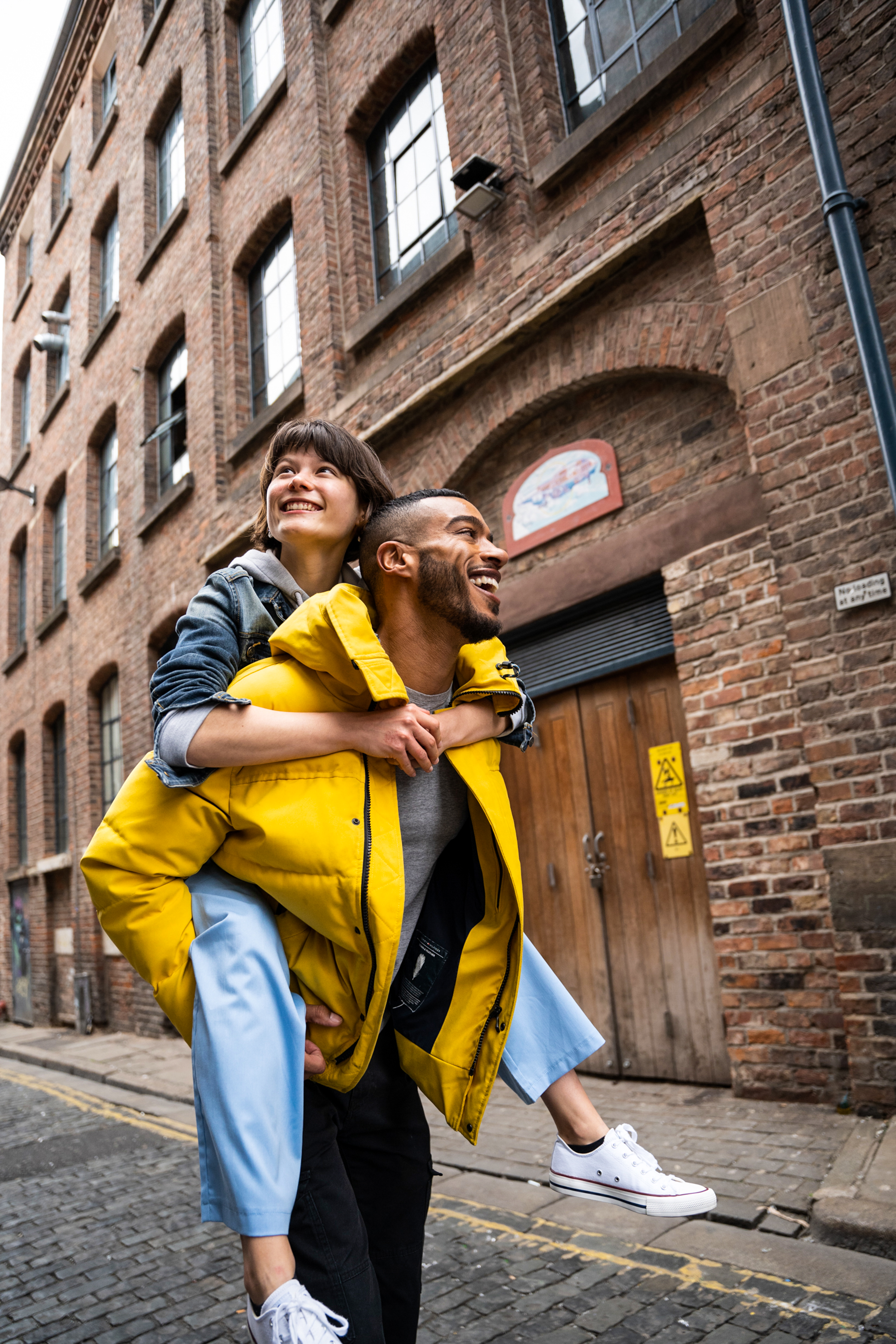 a man carrying a woman on his back